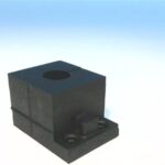 a black square component with a hole on top and a small protrusion on the side